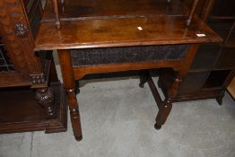 A period oak side table, having lincrusta style frieze panel
