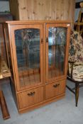 A vintage laminate display cabinet, approx dimensions W83cm H125cm D40cm