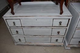 A 'shabby chic' chest of three drawers having ledge back Width approx. 99 cm