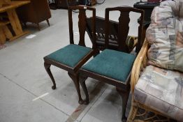 A pair of early 20th Century mahogany dining chairs having drop in seats