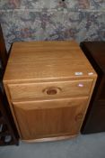 A light Ercol bedside cabinet