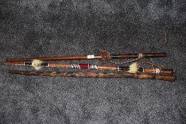 A selection of carved and leather work walking or ceremonial sticks