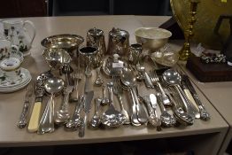 A large collection of platted ware including teapot,sugar and creamer, bowls and cutlery.