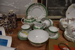 An antique part dinner service having white ground with green banding and gilt floral detailing