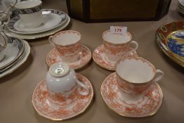 Four Doulton Burlsem coffee cups and saucers having musical instrument pattern an gilt edging.