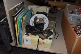 A selection of travel interest books, cameras and more.