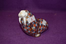 A Royal Crown Derby paperweight Walrus with a Silver stopper