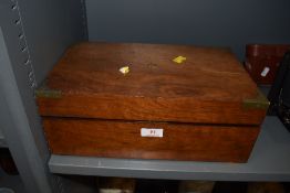 A mahogany cased writers compendium having brass corners and compartmental inner