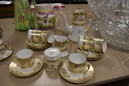 A part Noritake coffee set in cream and white with gilt floral detailing No 61640 included are six