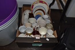 A box full of vintage and modern ceramics including display plates, commemorative cups, jugs and