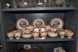 A large antique part tea service having Chinoserie print design with enamel detailing in hard