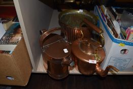 A brass and copper footed planter,a kettle and a hot water can.