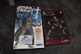 An X-men cyclops vinyl model kit and an empty Star wars Darth Vader limited edition figure box.