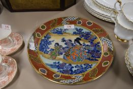 An oriental plate having character mark to back and transfer pattern to front with hand painted