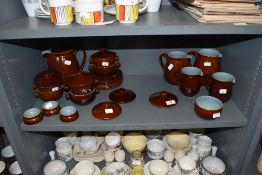 A selection of table wares by Denby in a brown and blue glaze including graduated jugs