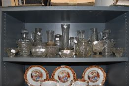 A selection of pressed and clear cut glass wares including light shades claret jug decanter etc