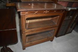 An early 20th Century light mahogany stacking style two tier bookcase, width approx. 94cm, height