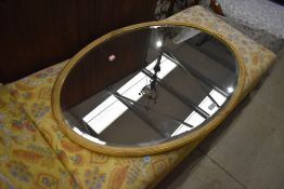 A gilt frame oval wall mirror, width approx. 93cm
