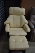 A modern cream stressless style armchair and footstool