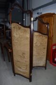 A Victorian mahogany trifold modesty screen having glazed upper panels and damask style lined lower,