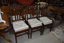 A set of six (four plus two) oak rail back dining chairs with later upholstered seats