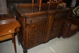 A mid 20th Century oak sideboard having ledge back, frieze drawers and double cupboard under,