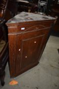 A 19th Century oak corner cupboard