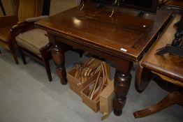 A mid 20th Century oak drawer leaf dining table