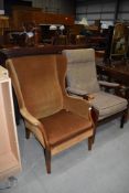 A vintage mustard dralon wing back chair and a modern wood frame armchair