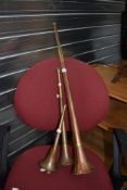 Three traditional copper and brass hunting horns