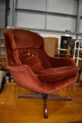 A vintage Eames style lounge chair, upholstered in orange dralon