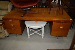 A vintage office desk, in teak, highly polished, with Chromed handles and legs, and very similar