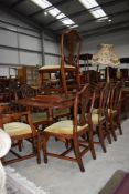 A reproduction Regency extending dining table and eight (six plus two) chairs