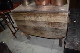 A traditional oak gateleg dining table`