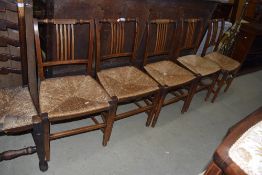 A set of five 19th Century rail back rush seated dining chairs