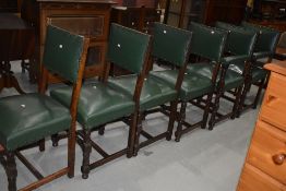 A set of six (four plus two) oak and green studded leather chairs, in the municipal style