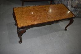 An early to mid 20th Century walnut coffee table having cabriole legs, approx. 107 x 46cm