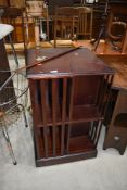 A reproduction mahogany effect revolving bookcase