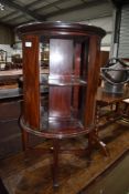 An Edwardian dark mahogany and inlaid revolving bookcase, a nice quality piece, varnish perishing