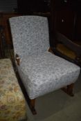 A traditional stained frame rocking chair having upholstered seat and back