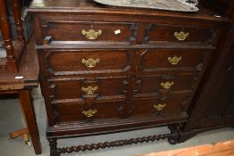 An early 20th Century Jacobean inspired chest on stand in dark oak