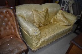An early 20th Century settee having later damask style loose cover, width approx. 183cm