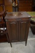 An early 20th Century mahogany enclosed music cabinet