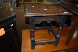 A period oak coffin type stool, approx. 40 x 32cm, old damage adds to the character of the piece