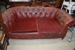 A late 19th or early 20th Century , red leather button back two seater settee having later dralon