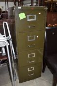 A vintage metal four drawer filing cabinet