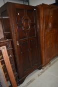 An early 20th Century Jacobean inspired wardrobe or hall robe in dark oak