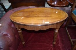 A reproduction mahogany Adams style oval coffee table, width approx. 69cm