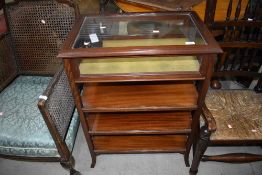 A traditional mahogany bijouterie table having display top over three shelves, simplistic frame