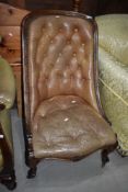 A 19th Century beige leather button back nursing chair on mahogany scroll frame`